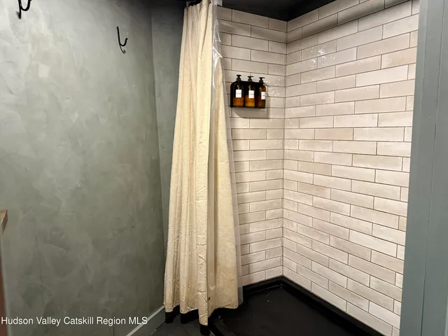 a view of a hallway with furniture and a window