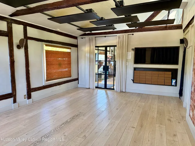 a view of an empty room with a fireplace and a window