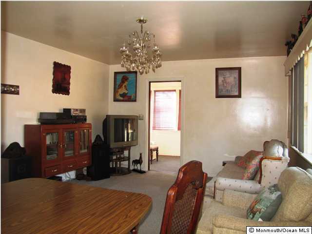 65 Thompson Bridge Road Jackson, NJ 08527 - Photo 3 of 3 a living room with furniture a fireplace and a chandelier