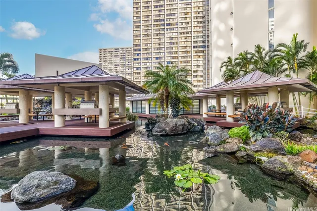 a front view of a house with swimming pool and porch