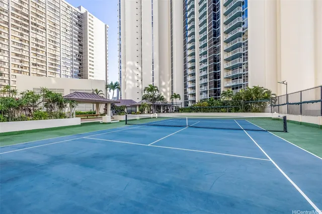a tennis court with view of buildings