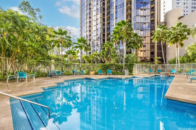 a view of swimming pool with outdoor seating and plants