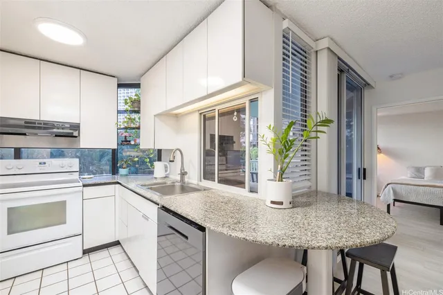 a kitchen with stainless steel appliances granite countertop a sink and a counter space