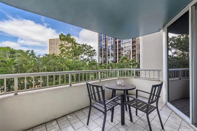 a view of a chairs and table in the balcony
