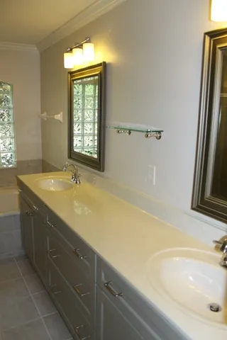 a bathroom with a tub sink and mirror