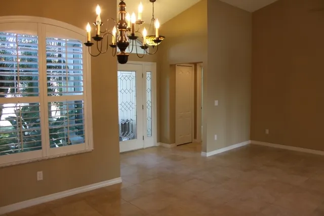 wooden floor in a room next to a large window