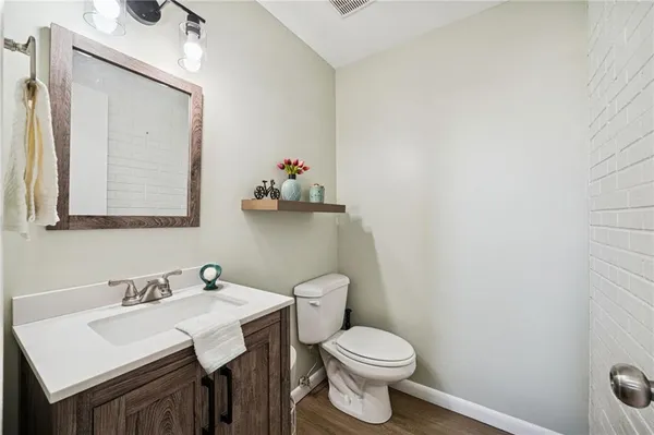 a bathroom with a toilet a sink and mirror