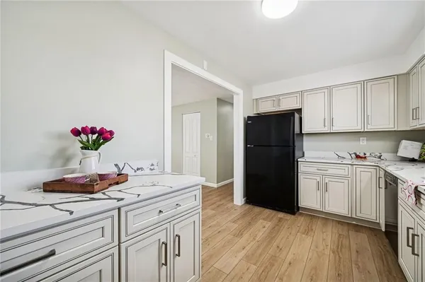 a kitchen with a refrigerator and cabinets