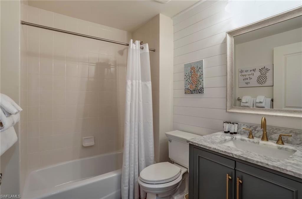 1045 Sandpiper Street, Unit G204 Naples, FL 34102 - Photo 19 of 40 a bathroom with a granite countertop sink toilet and shower