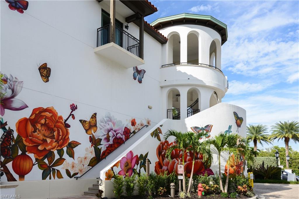1045 Sandpiper Street, Unit G204 Naples, FL 34102 - Photo 35 of 40 a front view of a house with lots of yellow lighting