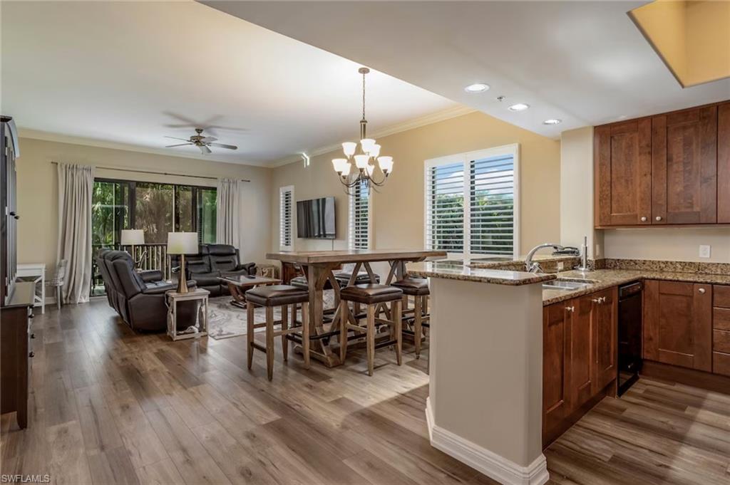 1045 Sandpiper Street, Unit G204 Naples, FL 34102 - Photo 40 of 40 a kitchen with lots of counter space dining table and chairs