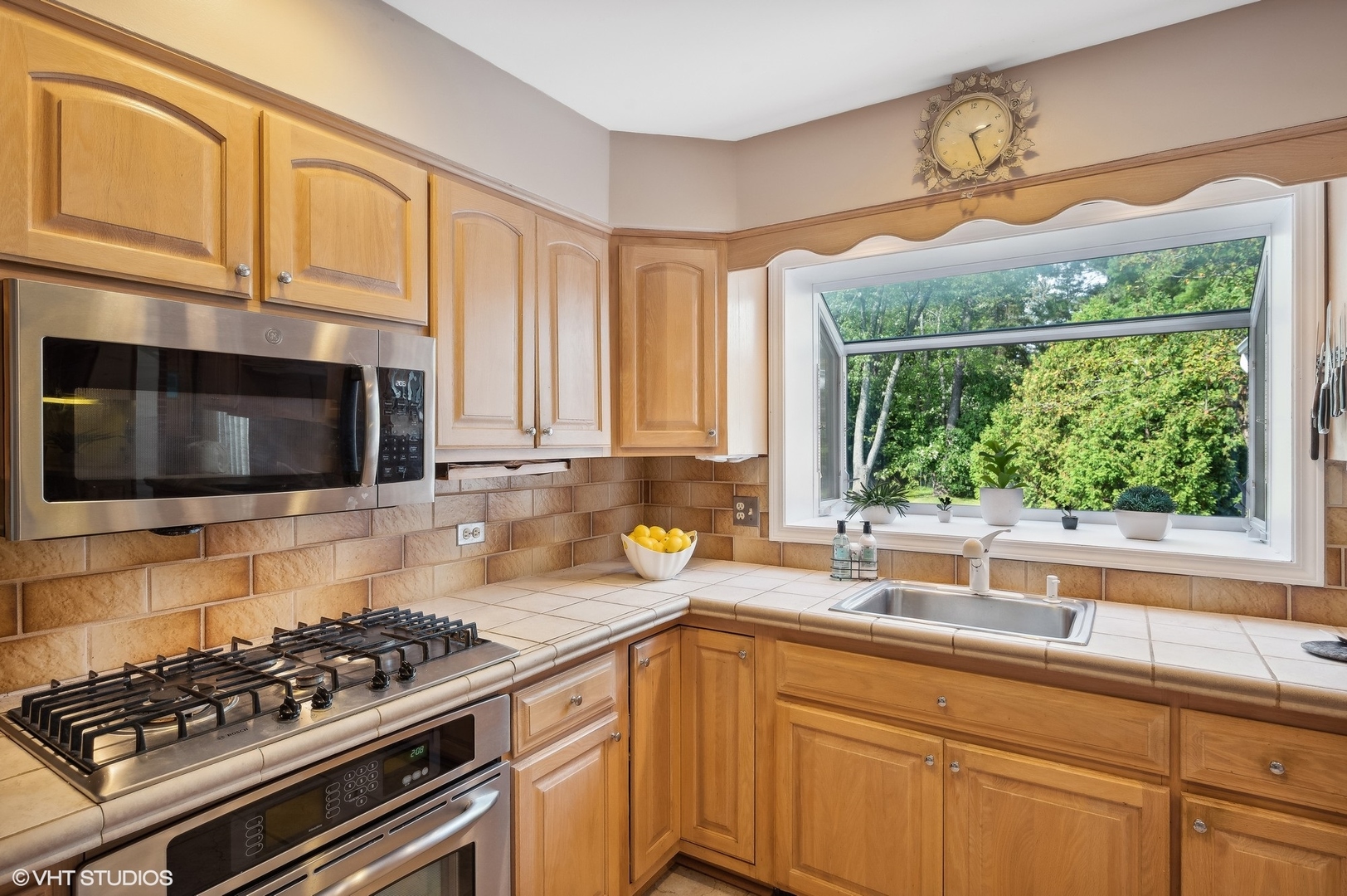 1404 Sequoia Trail Glenview, IL 60025 - Photo 11 of 46 a kitchen with stainless steel appliances granite countertop a stove a sink and a microwave