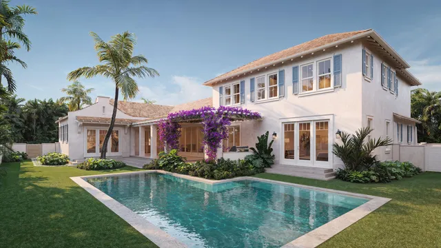 a front view of house and yard with swimming pool and trees in the background