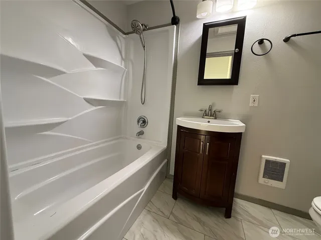 a view of an empty room with furniture