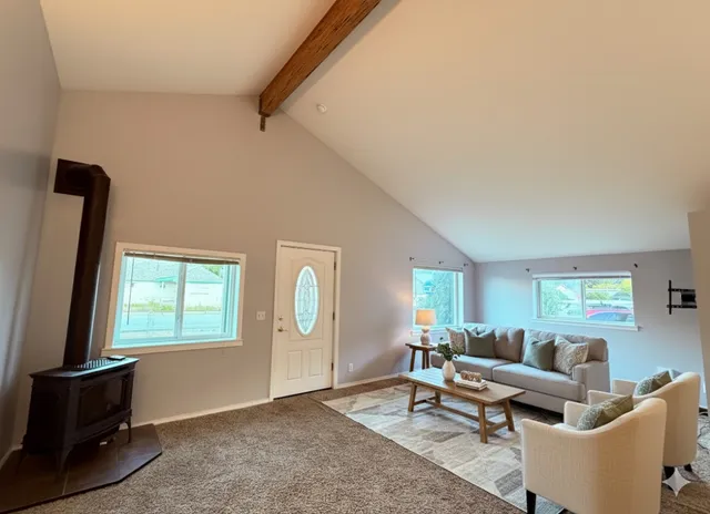a view of an empty room with closet and a window