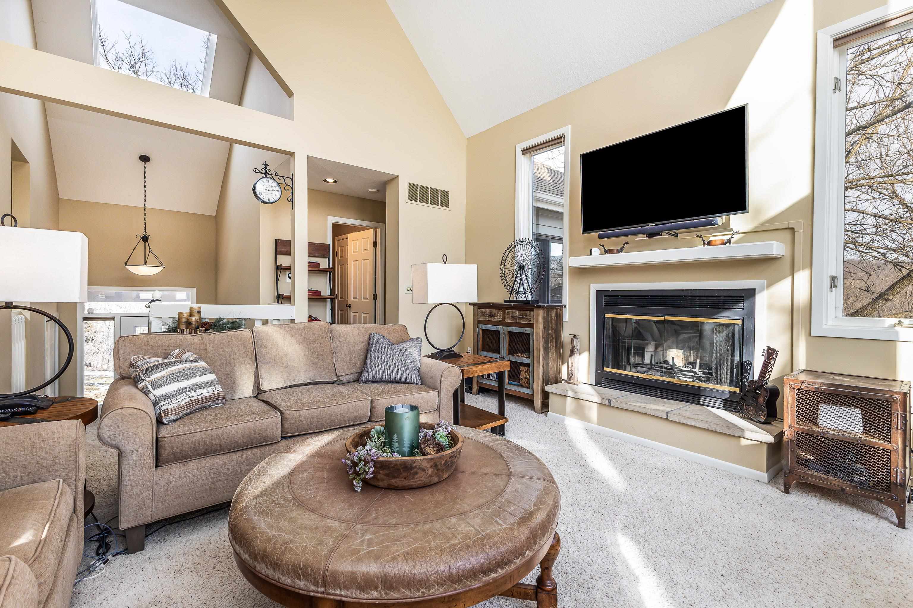 4 Timberline Drive Galena, IL 61036 - Photo 27 of 32 a living room with furniture a fireplace and a flat screen tv