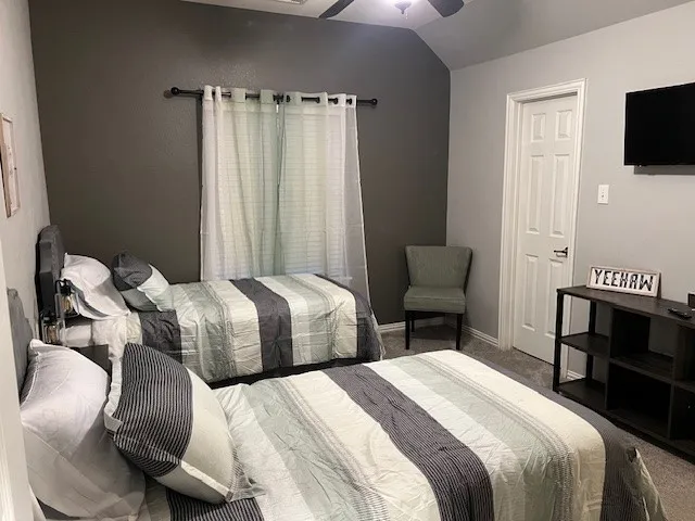 a bedroom with a bed and a television