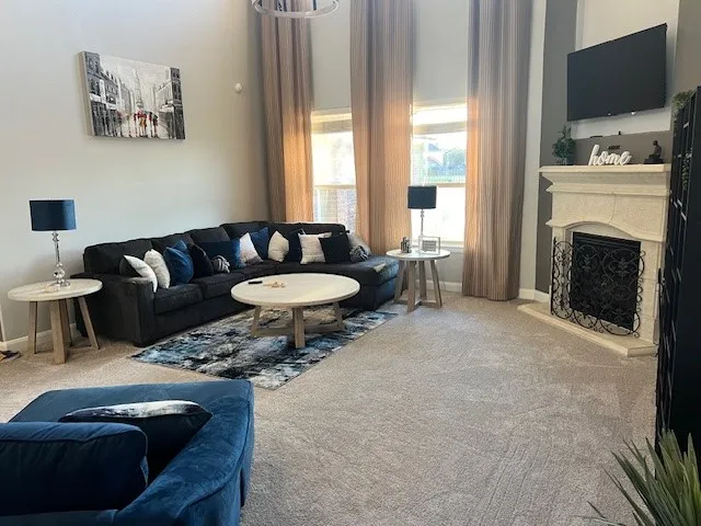 a living room with furniture and a fireplace