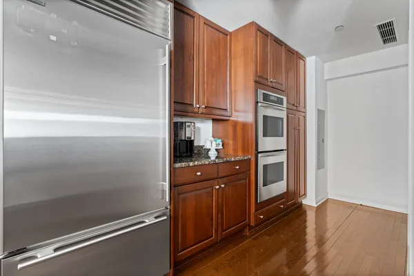 a kitchen with stainless steel appliances granite countertop a refrigerator and a stove