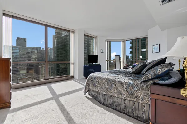 a bedroom with a bed and glass door