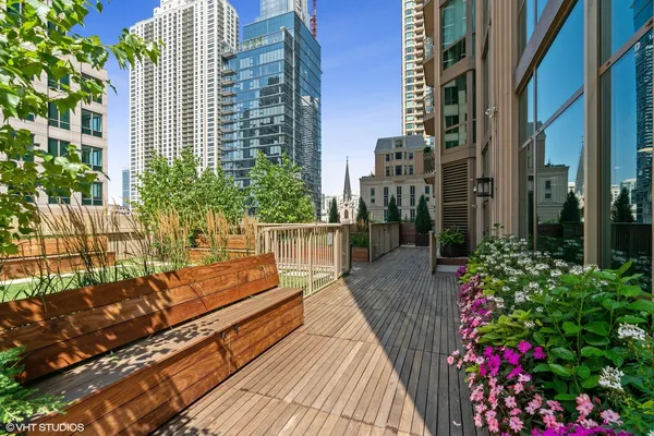 a balcony with flowers and wooden floor