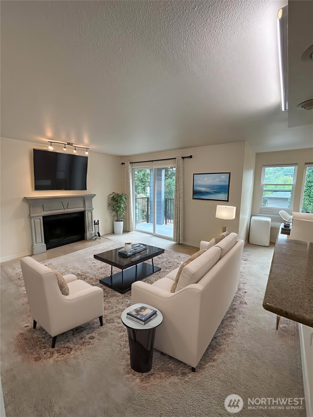 20318 Bothell Everett Highway, Unit A303 Bothell, WA 98012 - Photo 2 of 12 a living room with furniture and a fireplace