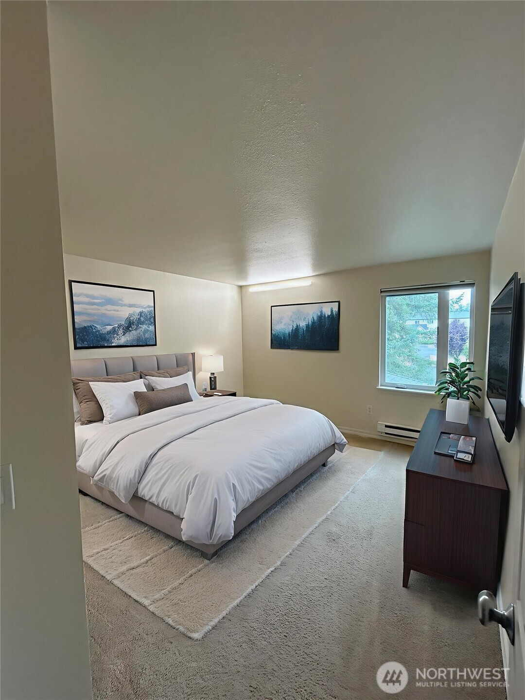 20318 Bothell Everett Highway, Unit A303 Bothell, WA 98012 - Photo 5 of 12 a bedroom with double bed and a couch