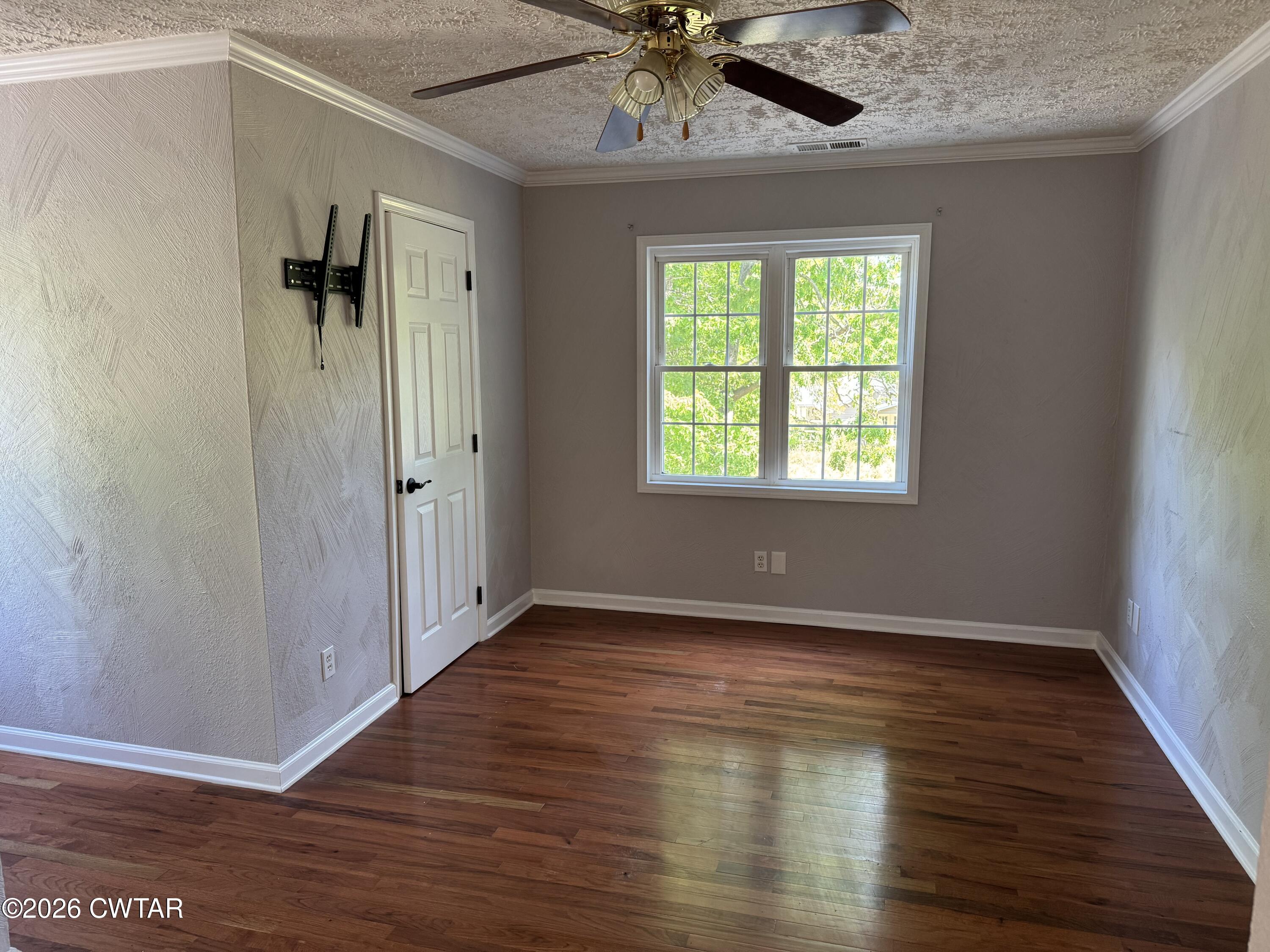 597 Broadway Road North Lexington, TN 38351 - Photo 11 of 15 a view of an empty room with a window and wooden floor