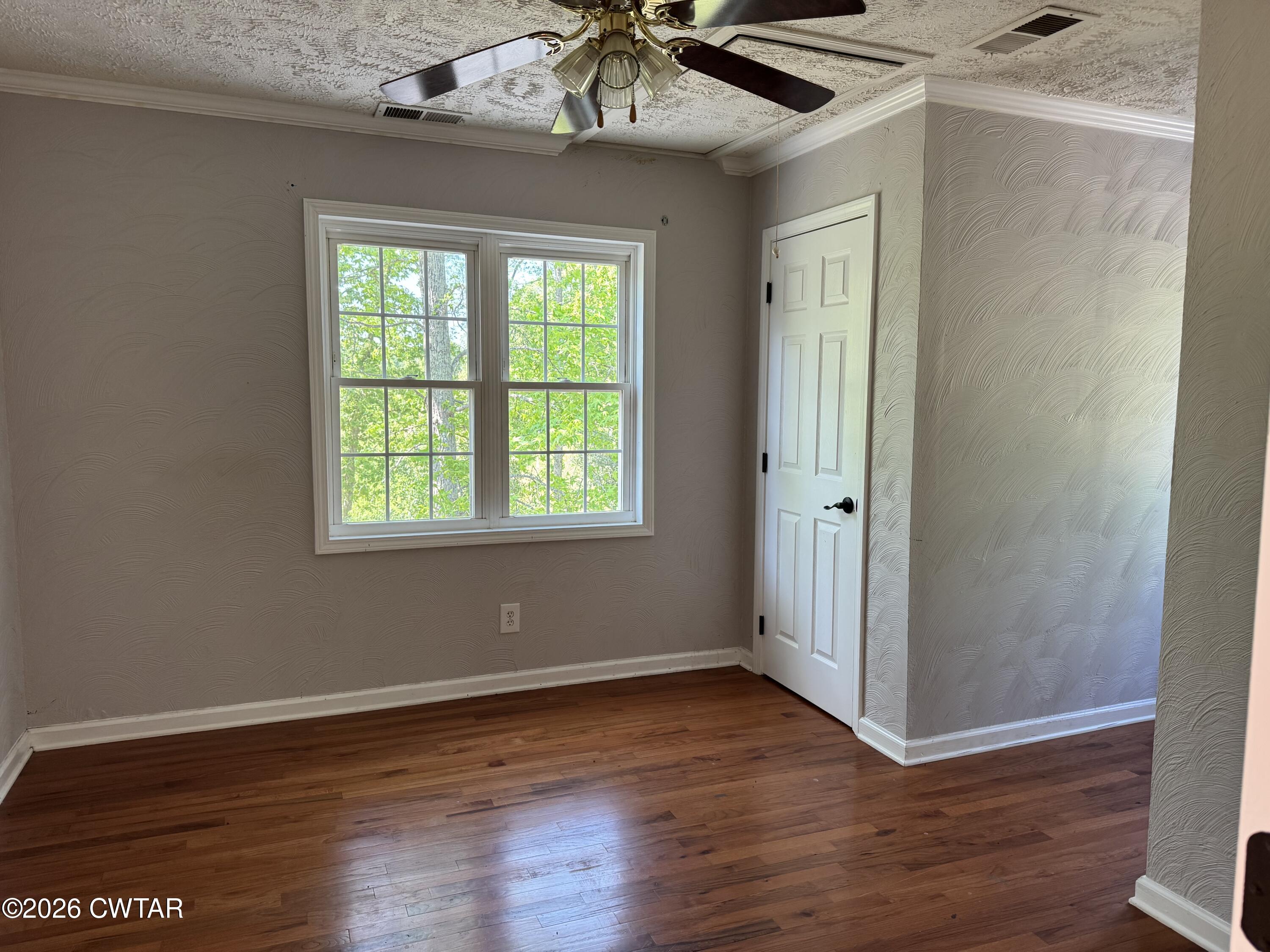 597 Broadway Road North Lexington, TN 38351 - Photo 12 of 15 wooden floor in an empty room with a window
