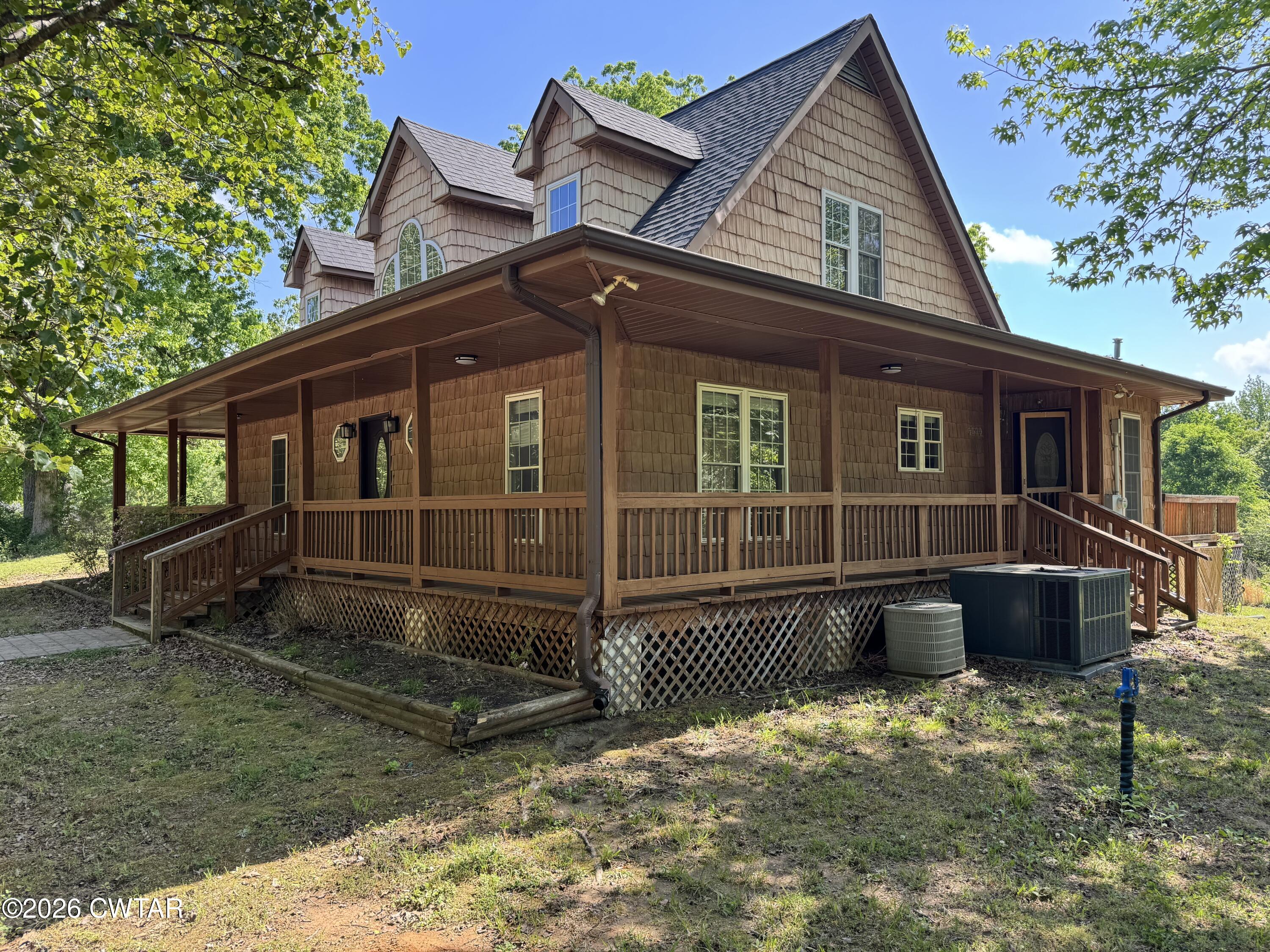 597 Broadway Road North Lexington, TN 38351 - Photo 15 of 15 a view of a house with a large window and wooden fence