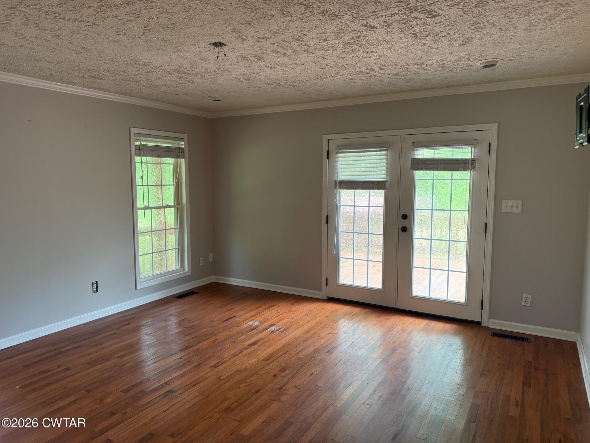 597 Broadway Road North Lexington, TN 38351 - Photo 7 of 15 a view of an empty room with wooden floor and a window