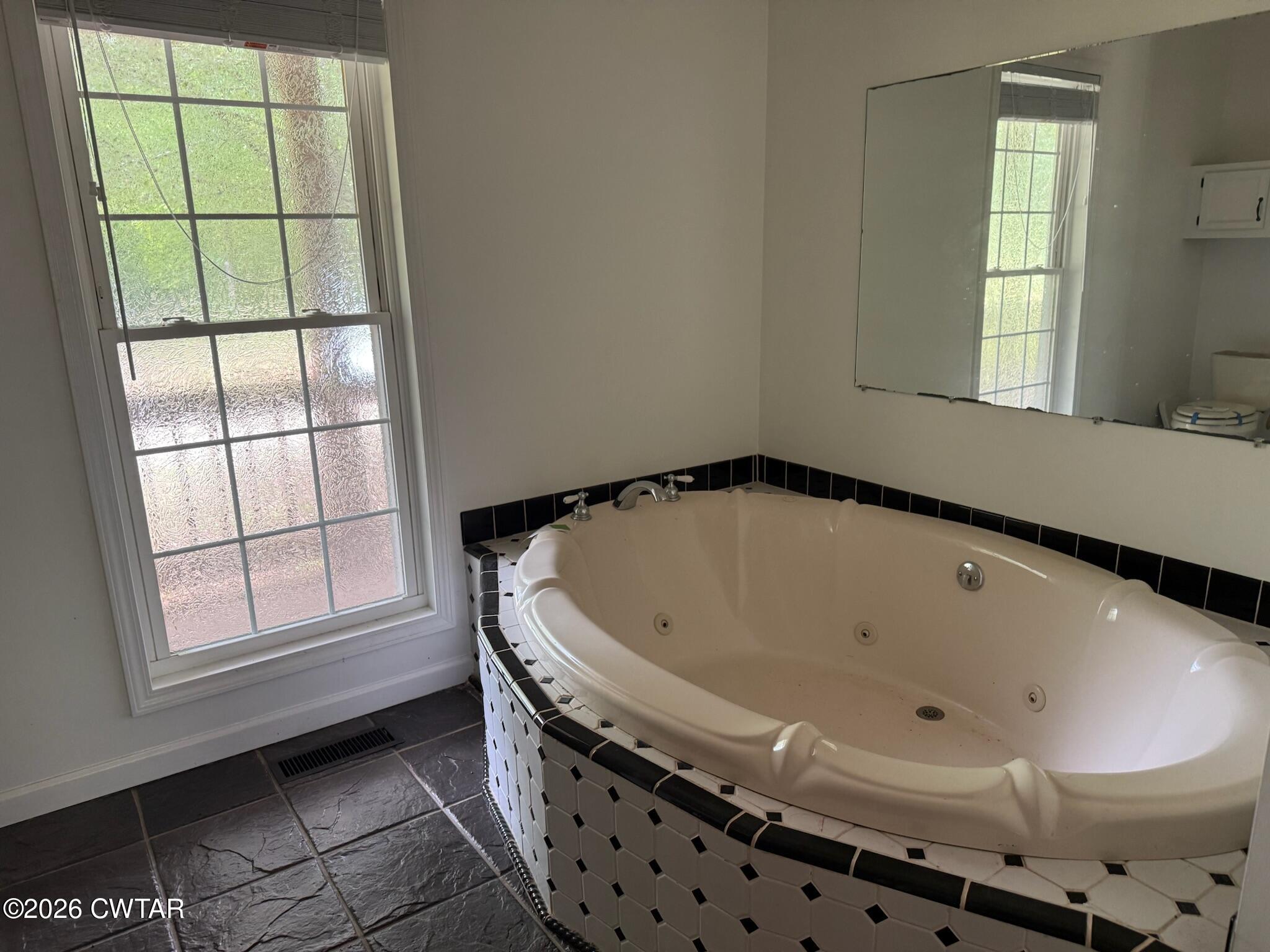 597 Broadway Road North Lexington, TN 38351 - Photo 10 of 15 a bath tub sitting in a bathroom next to a window
