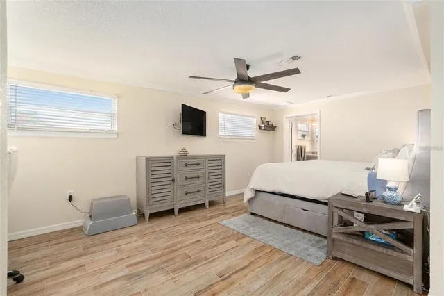 a bedroom with a bed a dresser and a window