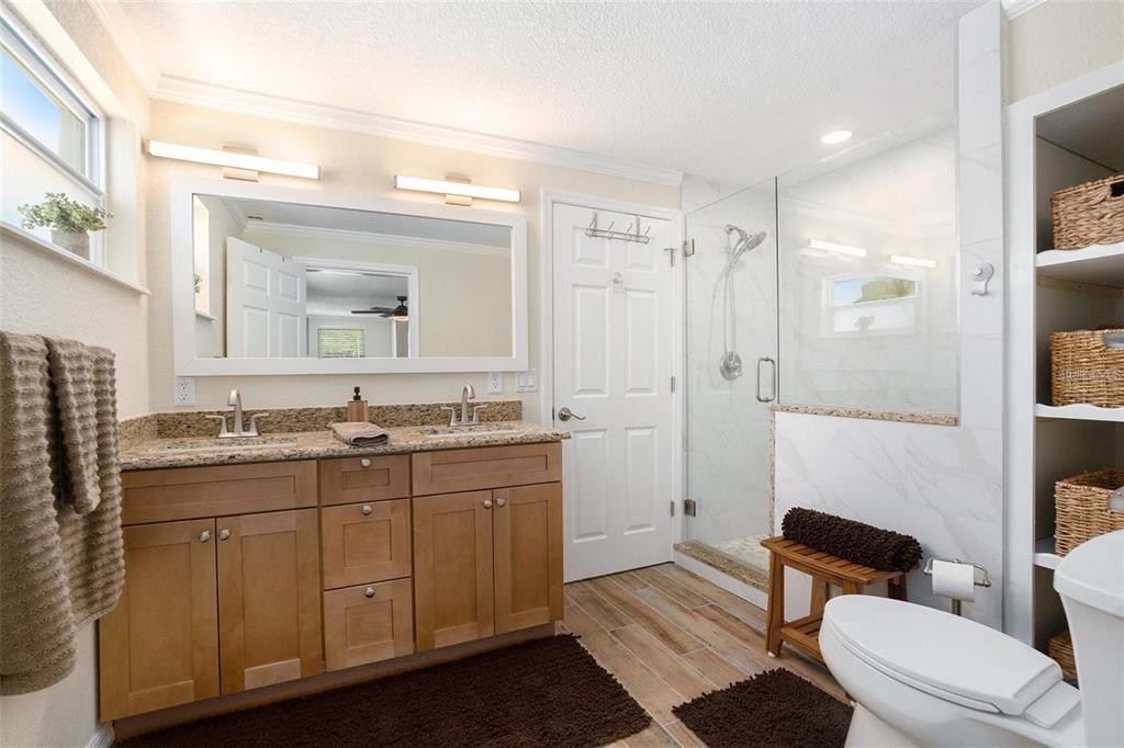 13401 Neptune Drive Hudson, FL 34667 - Photo 13 of 21 a bathroom with a toilet a sink and mirror