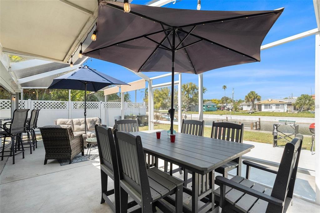 13401 Neptune Drive Hudson, FL 34667 - Photo 15 of 21 a view of a patio with furniture and a umbrella