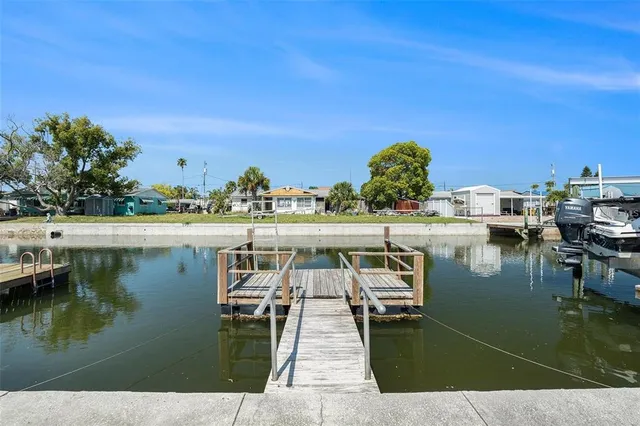 a view of a lake with chairs