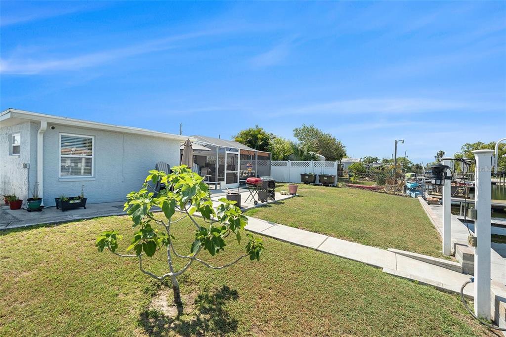 13401 Neptune Drive Hudson, FL 34667 - Photo 18 of 21 a swimming pool with outdoor seating and yard