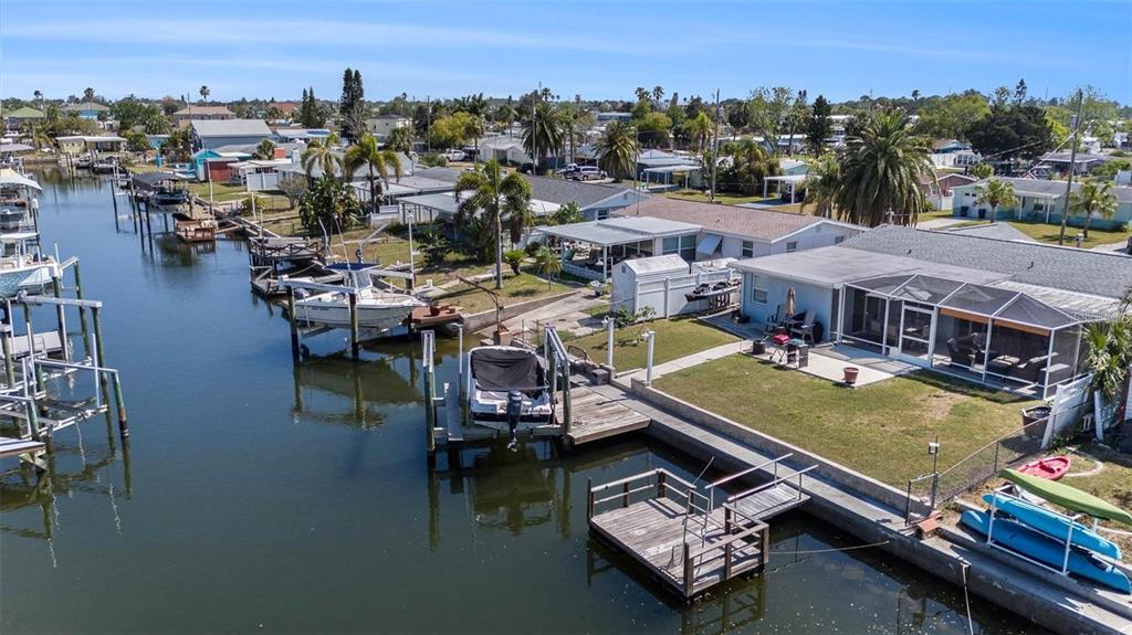 13401 Neptune Drive Hudson, FL 34667 - Photo 21 of 21 an aerial view of a house with swimming pool and lake view