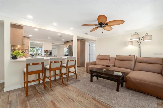 a living room with furniture a dining table and wooden floor