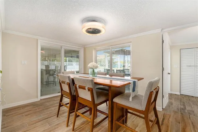 a dining room with furniture and wooden floor