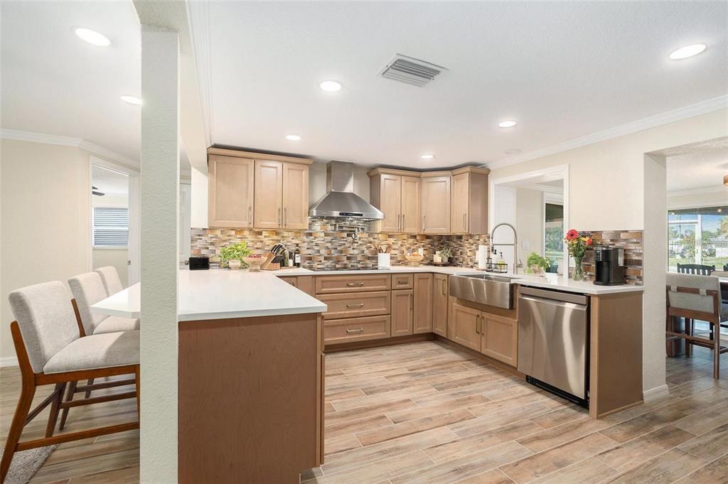 13401 Neptune Drive Hudson, FL 34667 - Photo 8 of 21 a kitchen with white cabinets and white appliances