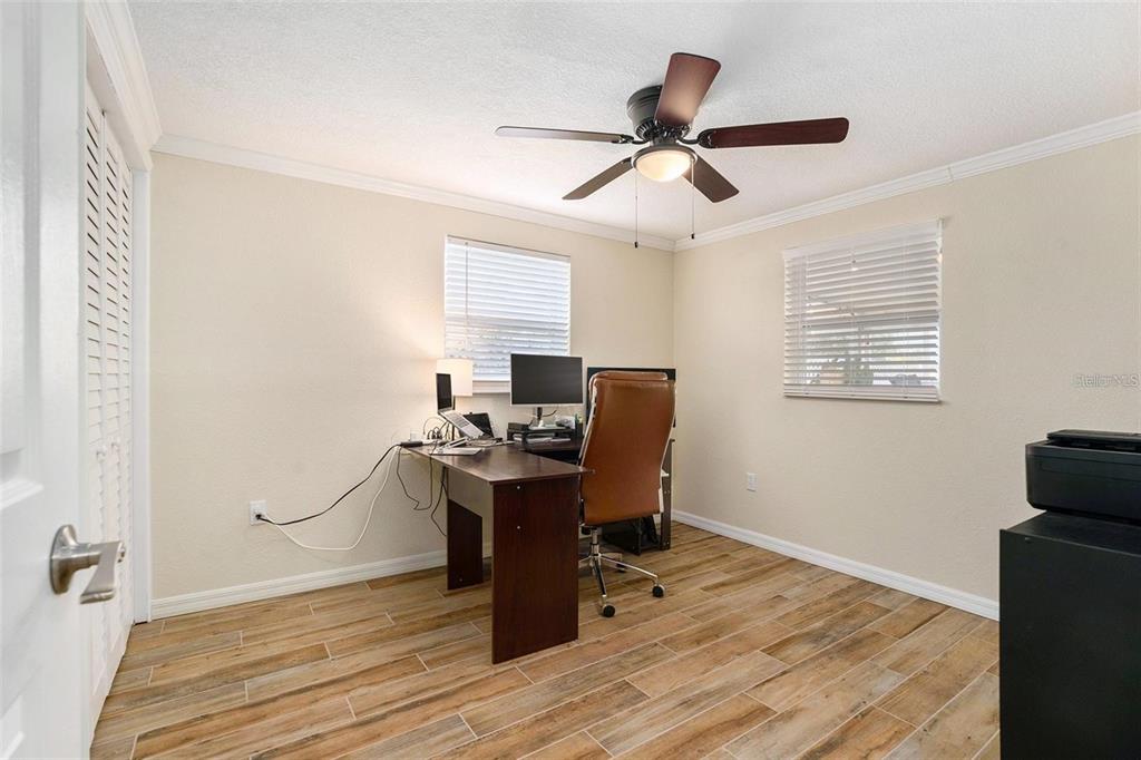 13401 Neptune Drive Hudson, FL 34667 - Photo 10 of 21 a view of a workspace with furniture and a window