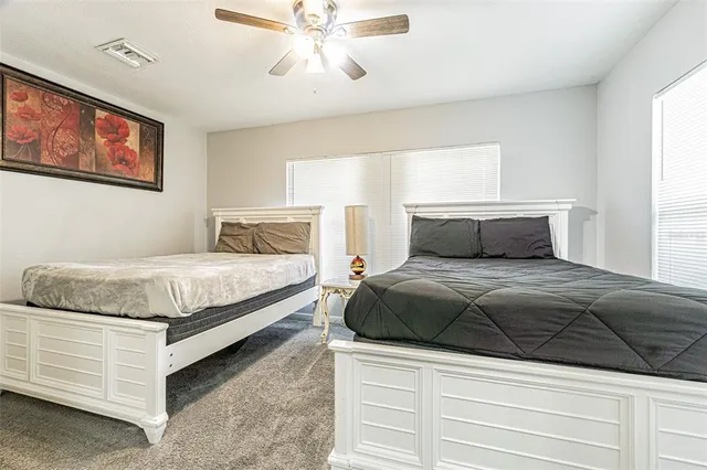 a bedroom with a large bed and a chandelier