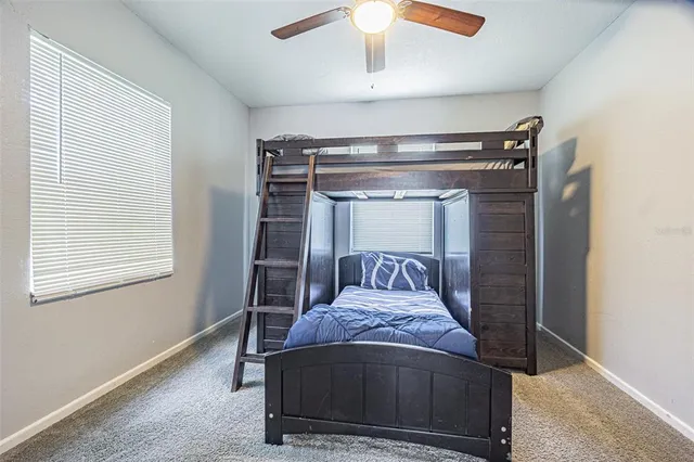 a bed sitting in a bedroom next to a window