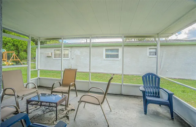 a patio with glass top table and chairs