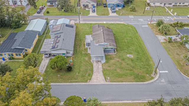 an aerial view of residential houses with outdoor space and swimming pool