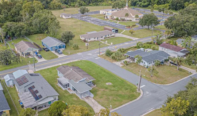 an aerial view of a house with outdoor space