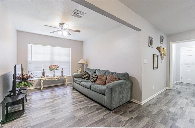 a living room with furniture and a large window