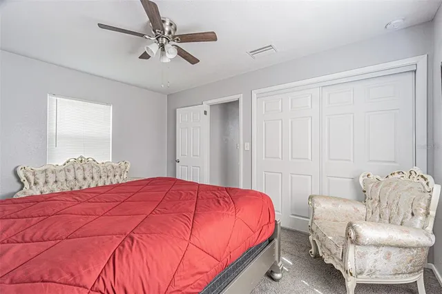 a bedroom with a bed and a couch