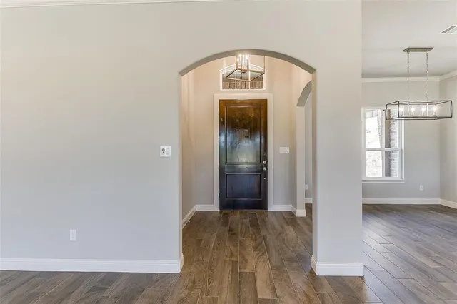 a view of hallway with wooden floor